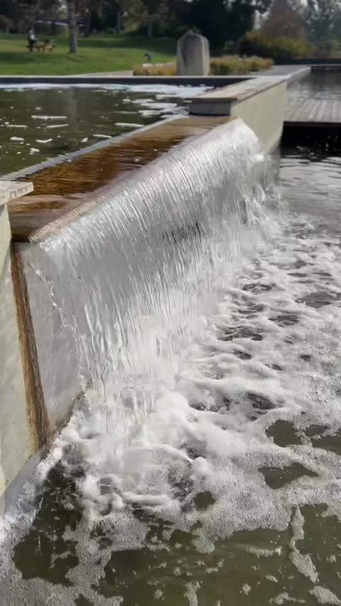 Cascading waterfall in a modern garden. Streams of water pour down. Vidéo 293454112
