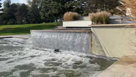 Cascading waterfall in a modern garden. Streams of water pour down. Stock Footage 293454126