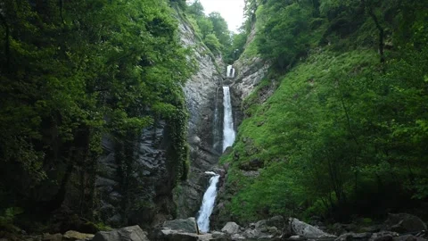 Cascading waterfall in the mountains Video stock 151684612