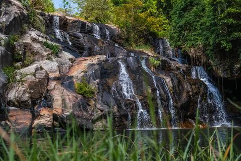 Cascading Waterfall Over Dark Rocks Stock Photos