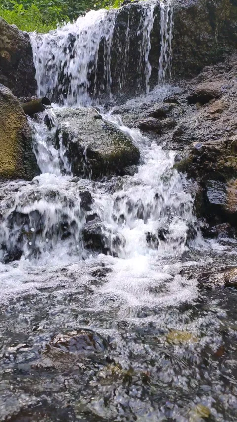 Cascading Waterfall Over Mossy Rocks in Malang Stock Footage 311449076