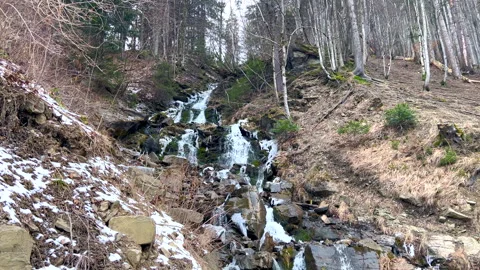 Cascading waterfall in snowy mountain forest Stock Footage 312756721
