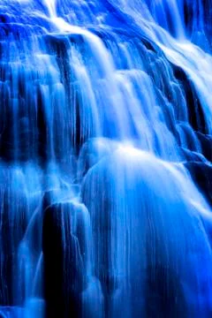 Cascading Waterfall Water Rolling Down Rocks to River Below Delicate Soft Blu Stock Photos