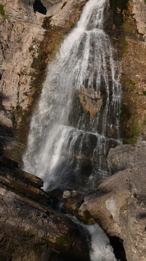 Cascading waterfalls in the evening sun, vertical shot Video stock 260871286