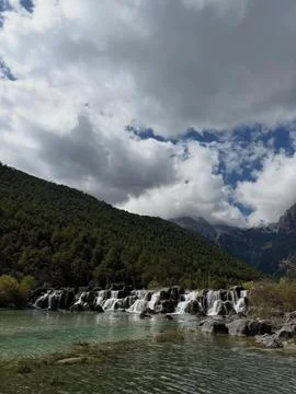Cascading Waters Beneath Brooding Clouded Sky. Stock Photos