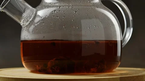 Cascara coffee cherry infusion steeps in glass teapot with condensation on Stock Footage 346585611