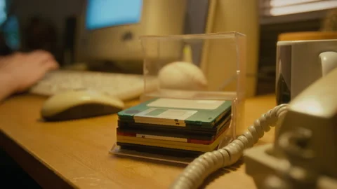 Case of Floppy Disks on Desk while Working on Retro Computer Stock Footage 327231084