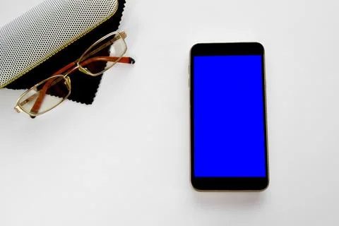Case with glasses and black tissue paper with smartphone blue screen mockup,  Stock Photos