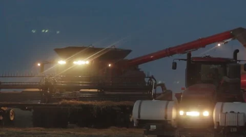 Case IH - Combine and Grain Cart - Evening Stock Footage 65318834