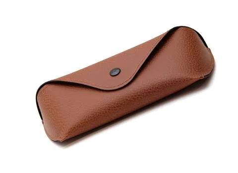 Case for storing glasses, brown, with a button, on an isolated white background Stock Photos