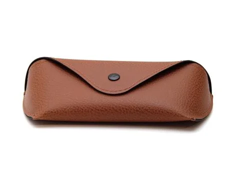 Case for storing glasses, brown, with a button, on an isolated white background Stock Photos