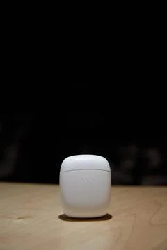 The case for wireless headphones is on the table the closed cover of the Stock Photos