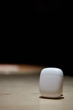 The case for wireless headphones is on the table the closed cover of the Stock Photos