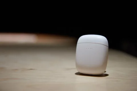 The case for wireless headphones is on the table the closed cover of the Stock Photos