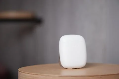 The case for wireless headphones is on the table the closed cover of the Stock Photos