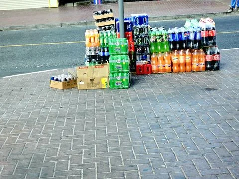 Cases of various soft drinks like Coca-Cola, Sprite, and Fanta are stacked Stock Photos