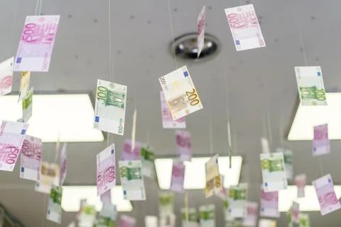 Cash bills hang on the thread from the ceiling. Stock Photos