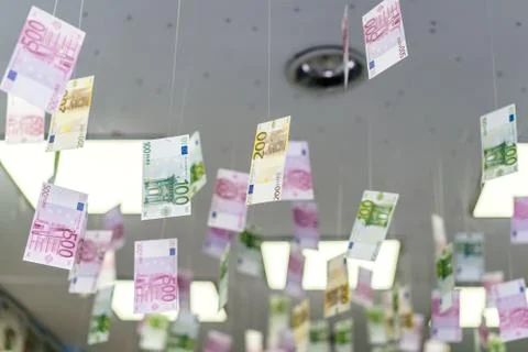 Cash bills hang on the thread from the ceiling. Stock Photos