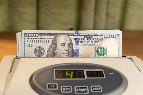 Cash counting machine with 100 US dollars stack close up Stock Photos