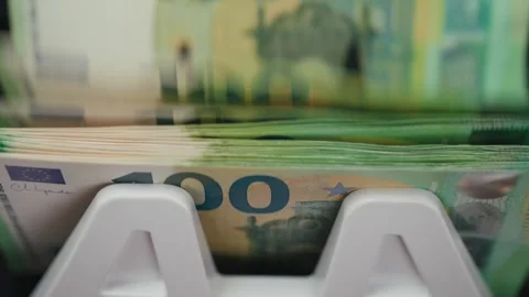 Cash counting machine processes euro banknotes, showing stacks of 100 euro notes Stock Footage 331079907