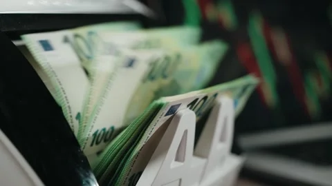 Cash counting machine processes euro banknotes in a close-up view, showing the Stock Footage 333978889