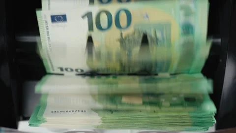 Cash counting machine processes stacks of 100 euro banknotes, showing continuous Stock Footage 331079989