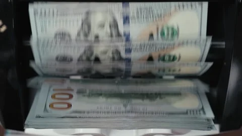 Cash counting machine processes stacks of hundred-dollar bills, showing the Stock Footage 331080003