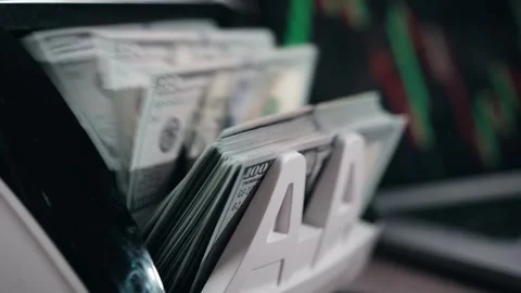 Cash counting machine processes stacks of hundred-dollar bills, showing Stock Footage 333978827