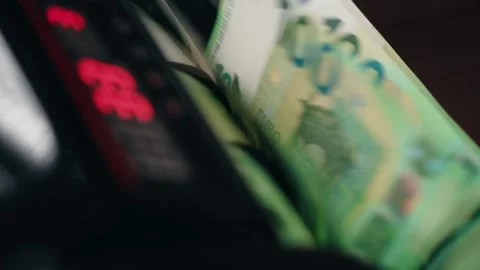 Cash counting machine processing euro banknotes in sequential order, displaying Stock Footage 331080092
