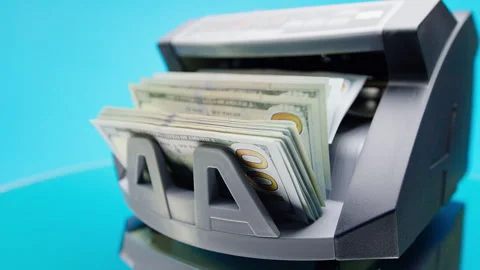 Cash Counting Machine Processing US Dollar Bills on Blue Stock Footage 339907272