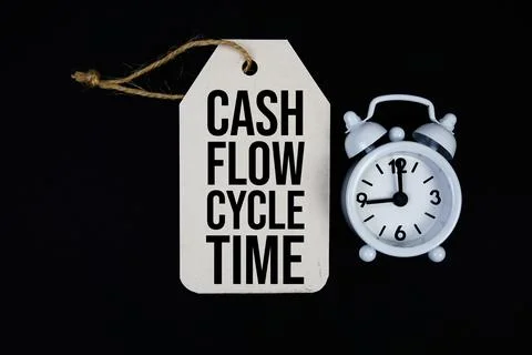 Cash Flow Cycle Time text on price tag with alarm clock on black background Stock Photos
