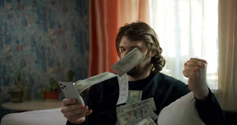 Cash flow, dollar bills floating in the man face. Online smartphone money rain Stock Footage 239915286