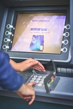 Cash is just a pin code away. Cropped shot of a woman entering her pin code at Foto stock