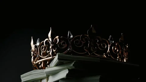 Cash Is King Concept Video Featuring an Gold Crown Spinning on Stacks of Money Stock Footage 335593598