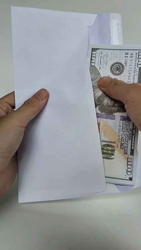 Cash money into envelope Stock Footage 329014468