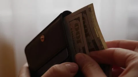 Cash Payment . Female hands pulling bills out of a purse. Stock Footage 305701899