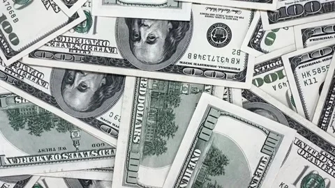 Cash is shown on a table in different arrangements. Each frame highlights the Stock Footage 328193594