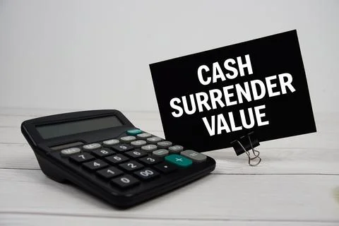 Cash Surrender Value text message on sticky note with calculator on wooden .. Stock Photos