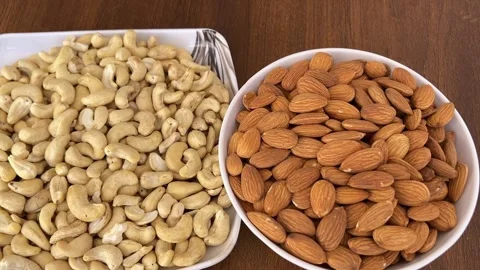 Cashew and Almonds Placed Separately on Two Plates | Healthy Dry Fruits 4K Stock Footage 323271602