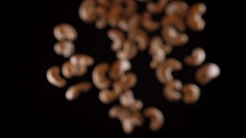 Cashew fly up and down on a black background. Cooking healthy food with cashew Stock Footage 126486777