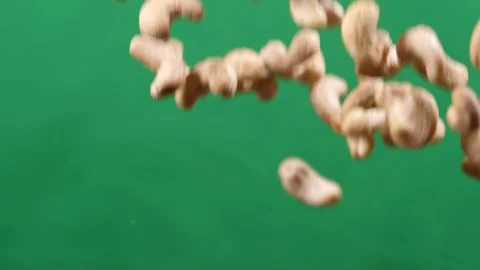 Cashew fly up and down on a green background. Cooking healthy food with cashew Stock Footage 128449862