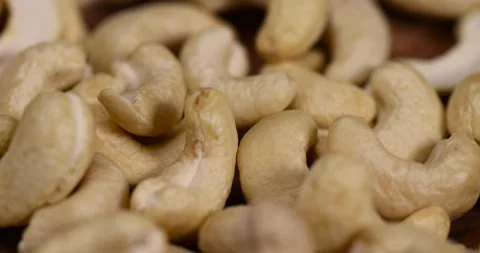 Cashew nuts are scattered on a larch board, raw unroasted cashew nuts are Video stock 301044254