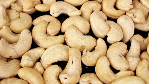 Cashew nuts closeup texture video on rolling rotating looping plate Stock Footage 104326908