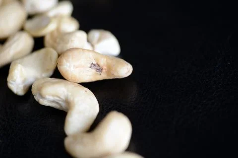 Cashew nuts on a dark background close up Stock Photos