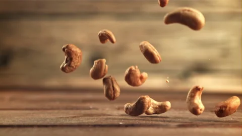 Cashew nuts fall on the table. Filmed is slow motion 1000 frames per second. Video stock 168170830