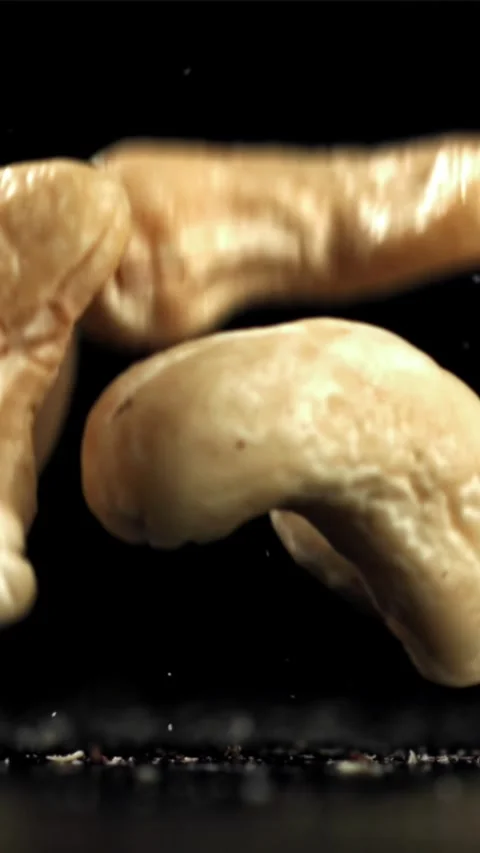 Cashew nuts fall on the table. Filmed on a high-speed camera at 1000 fps Stock Footage 335308690