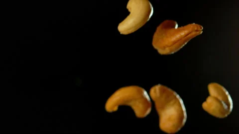 Cashew Nuts Falling with Black Background Slow Motion Stock Footage 159670877