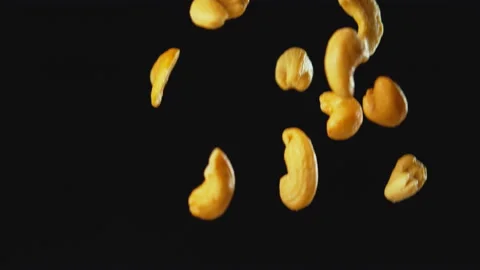 Cashew Nuts Falling with Black Background Slow Motion Stock Footage 159684278