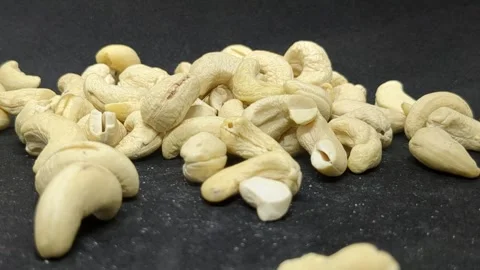 Cashew Nuts Falling Down in Black Background. Stock Footage 303747396