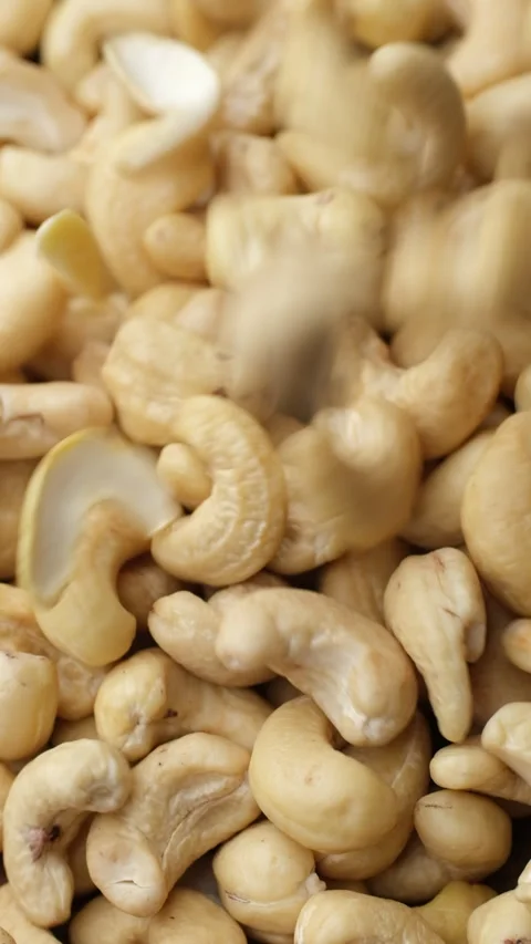 Cashew nuts falling down in plate, top view Stock Footage 282444186